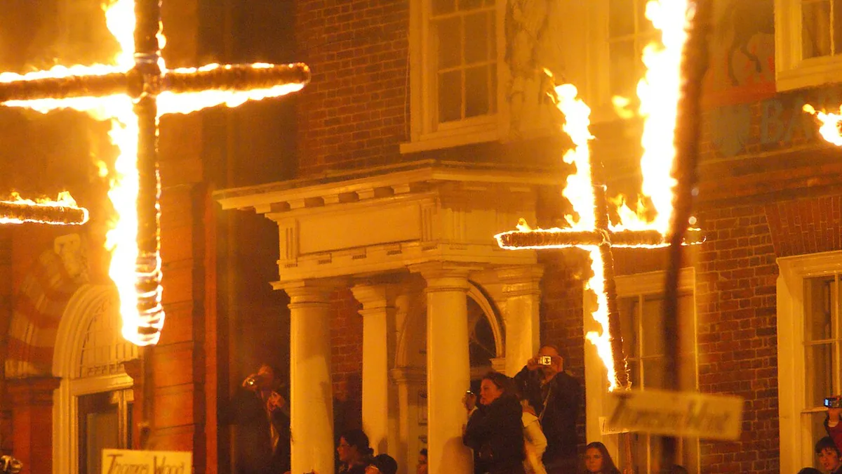 Burning crosses carried through a Lewes street on Bonfire Night